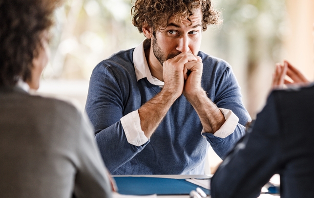 Man in meeting feeling anxious
